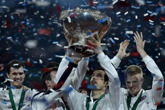 Britain's Andy Murray (2nd R) holds up the trophy next to Britain's Jamie Murray (L) and Britain's Kyle Edmund (R) as they celebrate after winning the Davis Cup tennis final against Belgium at Flanders Expo in Ghent on November 29, 2015. Britain won the Davis Cup for the first time in 79 years in Ghent on Sunday when Andy Murray defeated David Goffin 6-3, 7-5, 6-3, in the first of the reverse singles for an unbeatable 3-1 lead over Belgium. AFP PHOTO / JOHN THYSJOHN THYS/AFP/Getty Images