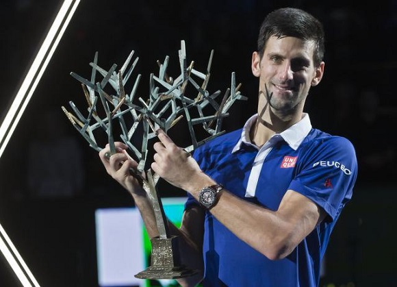Serbia's Novak Djokovic holds the trophy after winning the final of the BNP Masters tennis tournament in two sets, 6-2, 6-4, against Britain's Andy Murray at the Paris Bercy Arena, in Paris, France, Sunday, Nov. 8, 2015. (AP Photo/Michel Euler)
